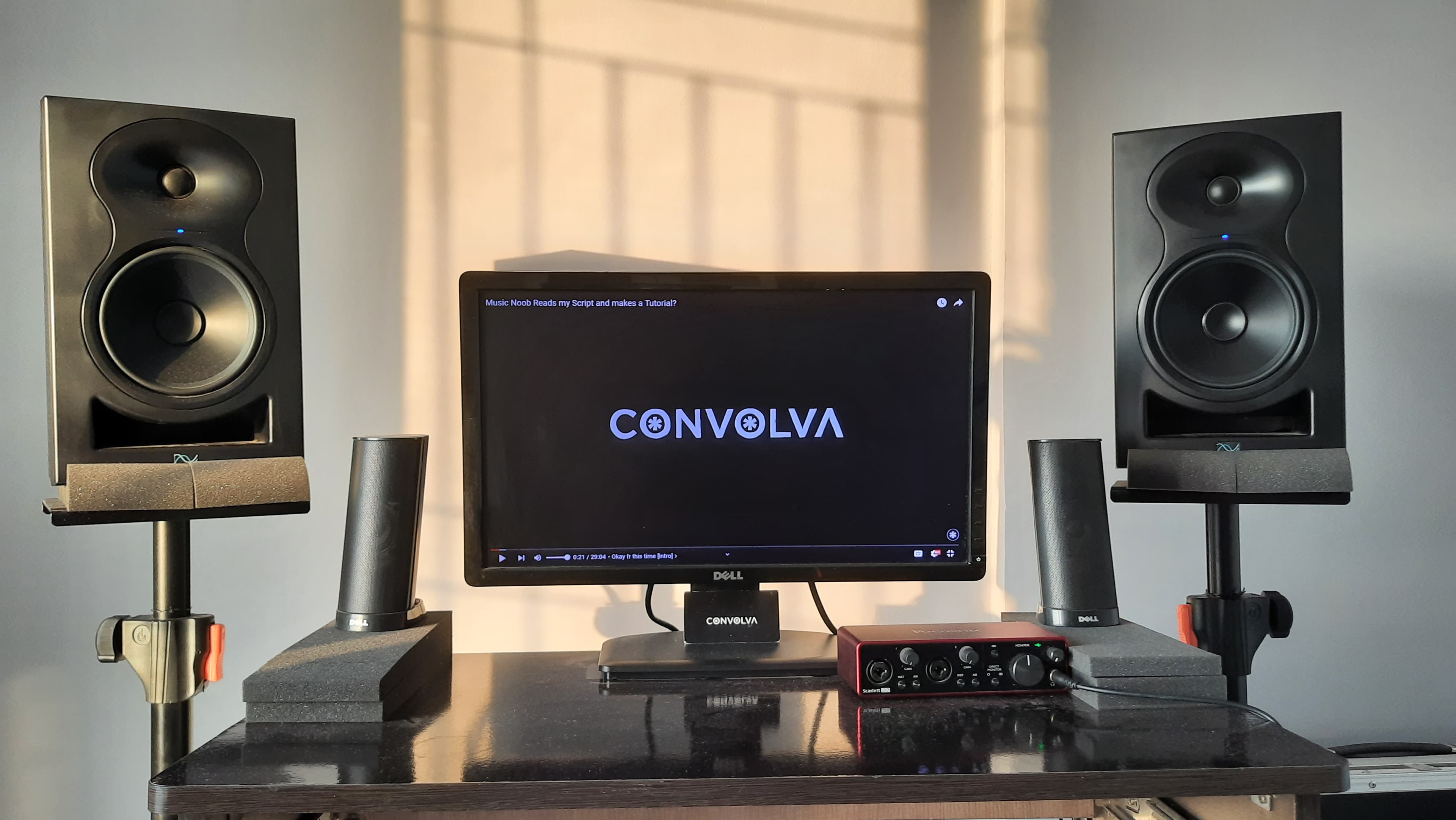 Convolva’s music production setup with studio monitors and a computer